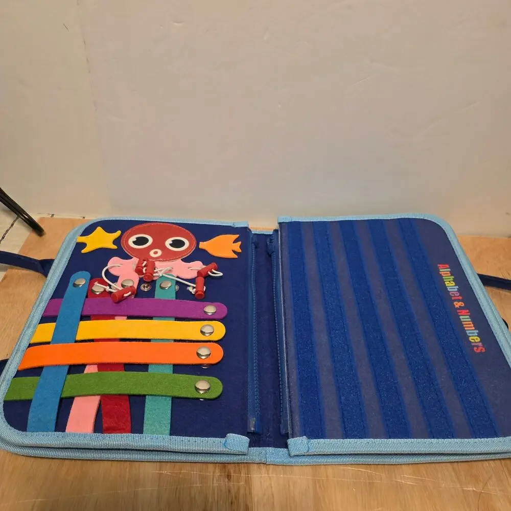 Esjay Toddler Busy Board in a portable dinosaur-themed felt carry case